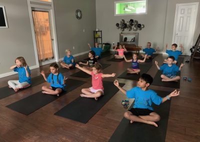 Practicing their mudras at Mindful Minis Camp